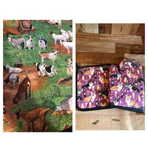May include: A set of two purple and black oven mitts with a pattern of corgis and wine glasses. The mitts are on a wooden surface.