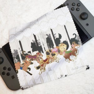 May include: A white microfiber cleaning cloth with a carousel design featuring colorful animals. The cloth has the text "The Tall Grass" in the bottom right corner.