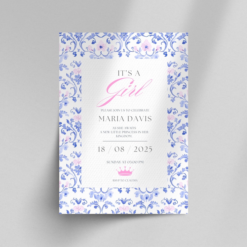 May include: A baby shower invitation with a blue and white floral pattern. The text reads "It's a Girl" in pink lettering, followed by "Please join us to celebrate Maria Davis as she awaits a new little princess in her kingdom. 18/08/2025 Sunday at 03:00 PM RSVP to Claudia."