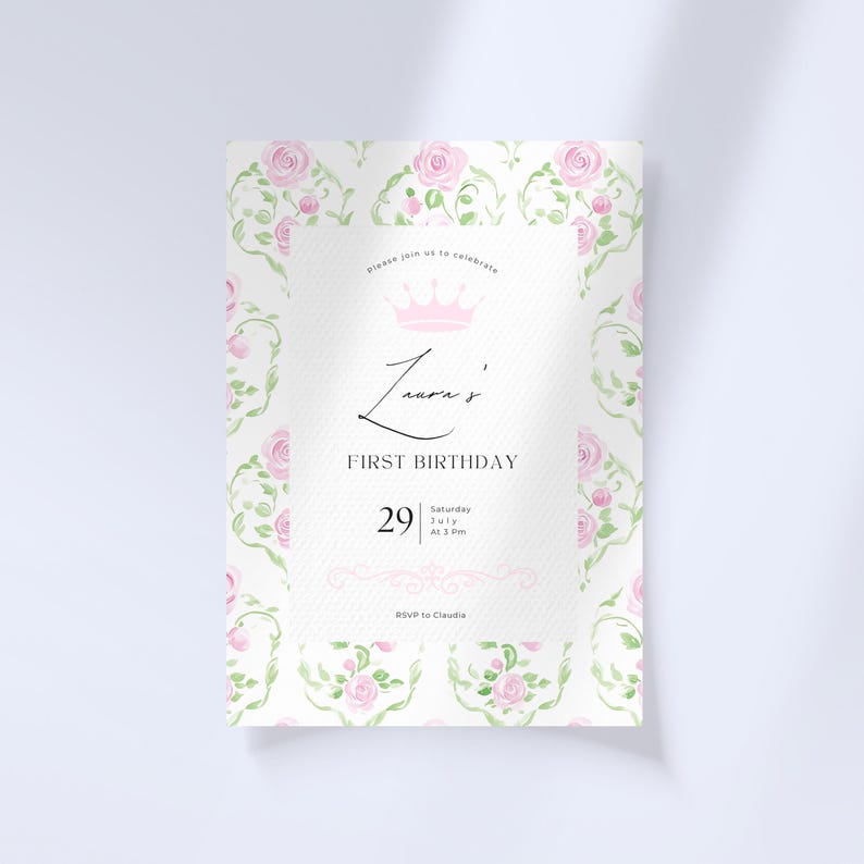 May include: A white invitation with a pink floral pattern and a crown. The text reads "Please join us to celebrate Laura's First Birthday, Saturday July 29 at 3 pm. RSVP to Claudia."