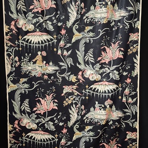 May include: Black fabric with a repeating pattern of pink and green flowers, birds, and people in a Chinese garden setting.
