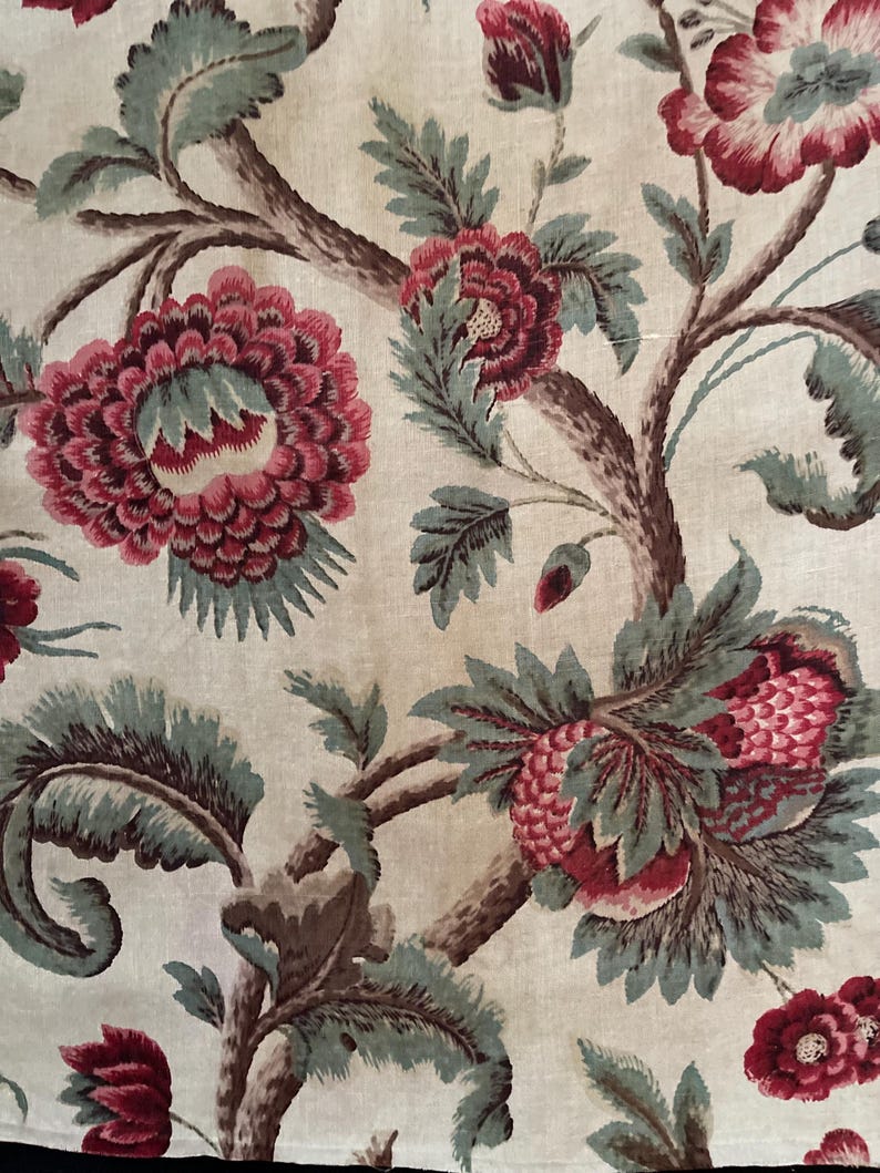 May include: A vintage fabric with a floral pattern. The fabric features a repeating design of pink and green flowers on a cream background.