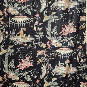 May include: Black fabric with a repeating pattern of pink and green flowers, birds, and people in a garden setting.