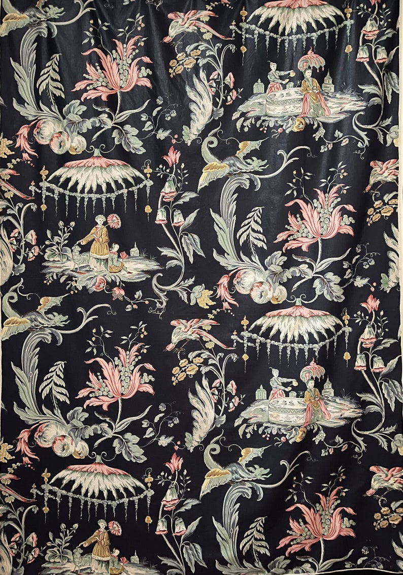 May include: Black fabric with a repeating pattern of pink and green flowers, birds, and people in a garden setting.
