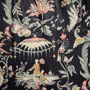 May include: Black fabric with a floral pattern featuring pink and green flowers, leaves, and a whimsical scene with figures under a canopy.