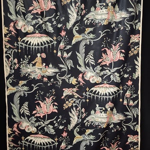 May include: Black fabric with a repeating pattern of pink flowers, green leaves, and white birds. The pattern also includes small figures of people in a garden setting.