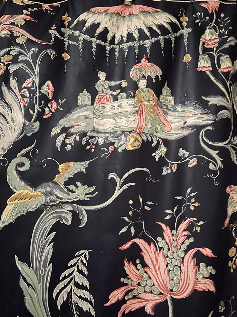 May include: Black fabric with a repeating pattern of stylized flowers, leaves, and a scene of two figures in a garden setting. The figures are wearing traditional clothing and are holding teacups.