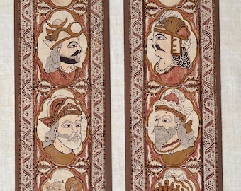 May include: Two vertical fabric panels featuring hand-painted portraits of eight figures in profile, arranged in four pairs. Each figure wears an ornate crown or headpiece and jewelry, rendered in shades of brown, cream, and red with intricate borders.