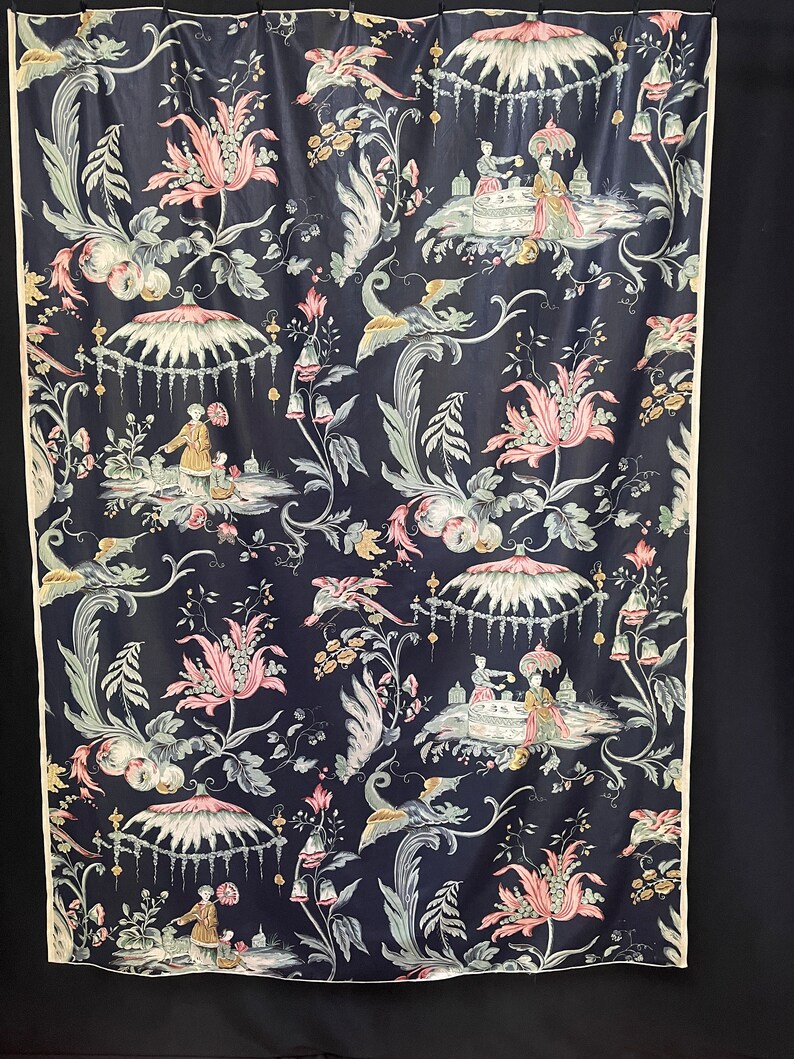 May include: A dark blue fabric with a repeating pattern of pink flowers, green leaves, and white figures in a landscape setting. The figures are wearing traditional Chinese clothing and are holding teacups.