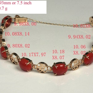 May include: A gold bracelet with red coral beads and Chinese characters. The bracelet is 7.5 inches long and weighs 10.7 grams. The measurements of each bead are listed on the image.