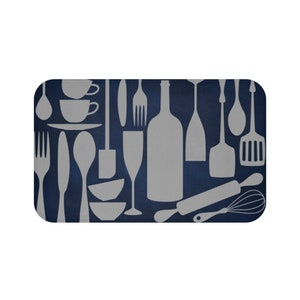 May include: A navy blue kitchen mat with a pattern of various kitchen utensils in a light gray color. The utensils include forks, spoons, knives, wine bottles, rolling pins, spatulas, and whisks.