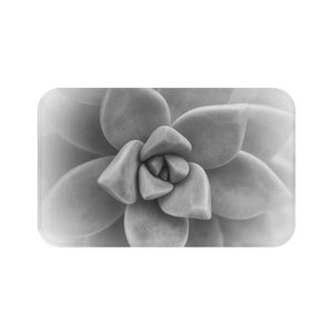 May include: A grayscale image of a succulent plant, featuring tightly packed, fleshy leaves in a rosette pattern. The leaves have a smooth texture and gradient shading, creating depth and dimension. The image is a close-up, highlighting the plant's intricate details.