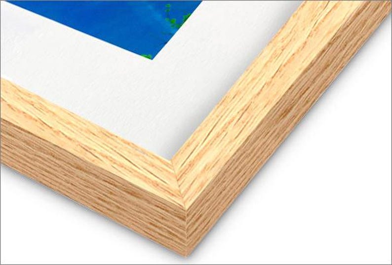 May include: Close-up of the corner of a natural wood picture frame. The frame has a light brown color and a smooth, slightly textured surface.