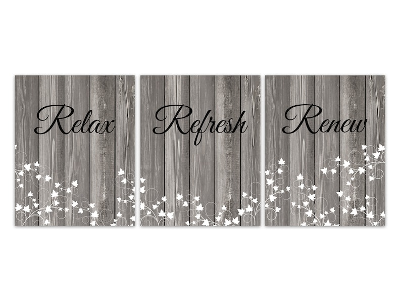 May include: Three wood-grain panels with white floral designs and the words "Relax", "Refresh", and "Renew" in black lettering.