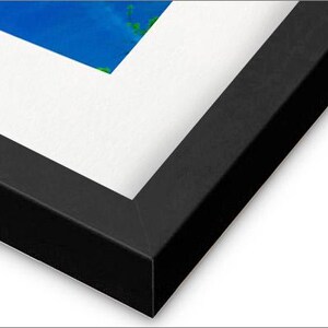 May include: A black picture frame with a white mat. The frame is made of wood and has a smooth finish.