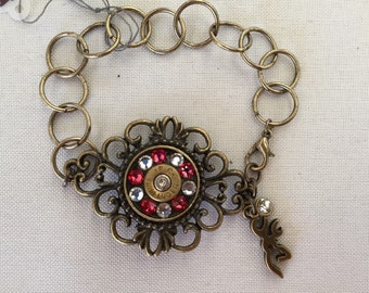 Bronze swavorski filigree bracelet with 9mm bullest casing, browning charm, and clear crystal charm