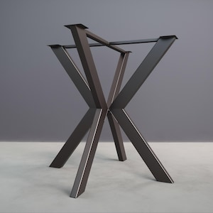 May include: Black metal table base with a geometric X-shaped design. The base is made of sturdy metal and has a sleek, modern look.