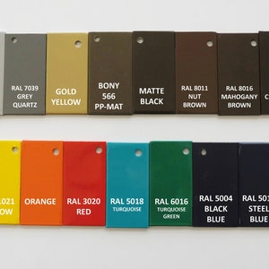 May include: A collection of color swatches in various shades, including white, gray, gold, brown, and black. Each swatch is labeled with its color name and a corresponding RAL code. Additional colors include yellow, orange, red, turquoise, green, and blue.