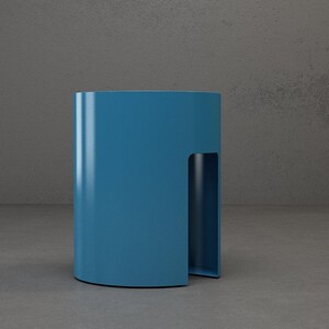 A blue cylindrical side table with a cut-out on one side.