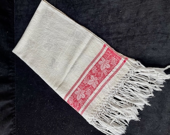 Vintage linen damask towel with red vine patterns and fringes. Around 1920's