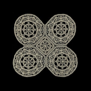 May include: A cream-colored, handmade lace doily with a four-leaf clover design. The doily features intricate floral and circular patterns, with a square center. The delicate lace is set against a black background.