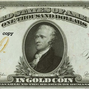 May include: A vintage $1000 United States of America bill. The bill features a portrait of Alexander Hamilton and the text "IN GOLD COIN". The bill has the text "kokopellie's copy" and the serial number D141884. The bill is primarily green and black.