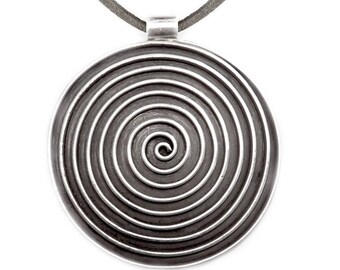 May include: A silver pendant necklace with a circular design featuring a spiral pattern. The pendant is made of metal and has a smooth, polished finish.