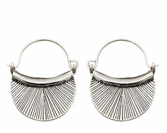 May include: A pair of silver hoop earrings with a decorative fan-shaped design. The earrings are made of metal and have a simple, elegant style.