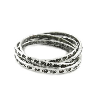 May include: A silver ring with a textured design. The ring is made of four bands that are intertwined.