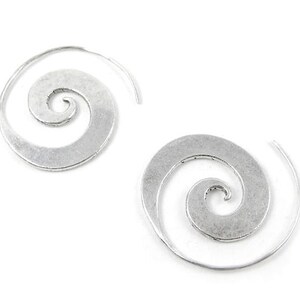 May include: A pair of silver spiral hoop earrings. The earrings are made of metal and have a simple, elegant design.