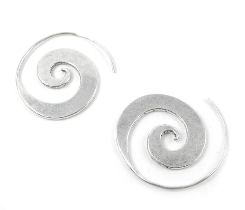 May include: A pair of silver spiral hoop earrings. The earrings are made of metal and have a simple, elegant design.