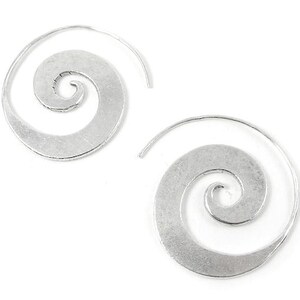 May include: A pair of silver spiral hoop earrings. The earrings are made of metal and have a smooth, polished finish.