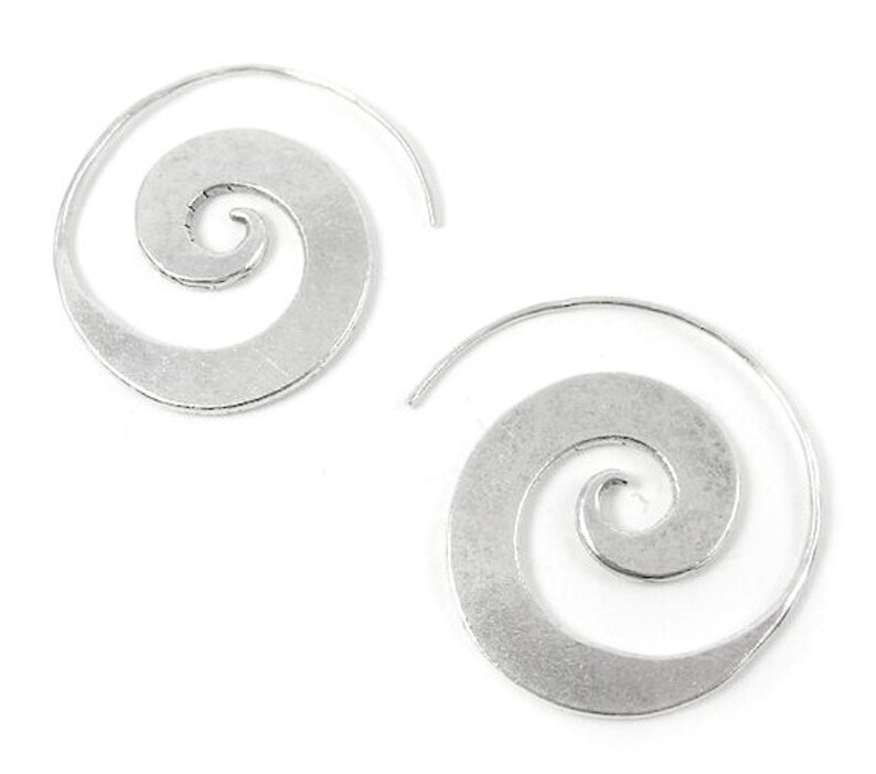 May include: A pair of silver spiral hoop earrings. The earrings are made of metal and have a smooth, polished finish.