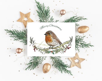 May include: A white Christmas card with a green and red robin perched on a branch with berries. The card has the text "Merry Christmas" written in green cursive.