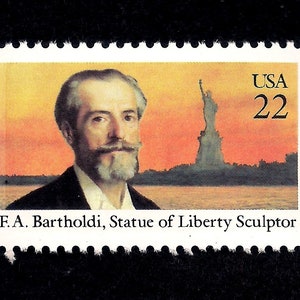 May include: A postage stamp featuring a portrait of F.A. Bartholdi, the Statue of Liberty sculptor, with the Statue of Liberty in the background. The stamp is marked "USA 22" and includes the text "F.A. Bartholdi, Statue of Liberty Sculptor."