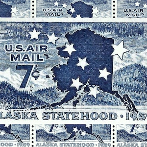 May include: A blue and white stamp with a map of Alaska and the text "U.S. AIR MAIL 7¢ ALASKA STATEHOOD 1959".