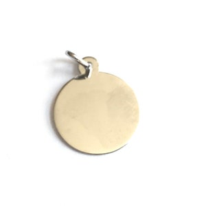 May include: A silver round charm with a smooth surface and a small loop at the top.
