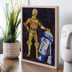 May include: A framed collage artwork featuring C-3PO and R2-D2 from Star Wars. The artwork is made of paper and has a vintage, distressed look.