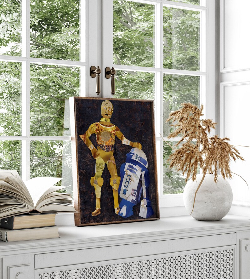 May include: A framed collage art print featuring a gold robot character from Star Wars, C-3PO, standing next to a blue and white robot, R2-D2. The background is a dark brown color.