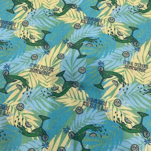 May include: Fabric with a repeating pattern of green margarita glasses, lime slices, and palm fronds on a blue and yellow background. The text "IT'S 5 O'CLOCK SOMEWHERE" is printed throughout the design.