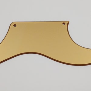May include: Gold-colored guitar pickguard with four screw holes.