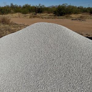 May include: A large pile of white gravel, likely used for landscaping or construction.