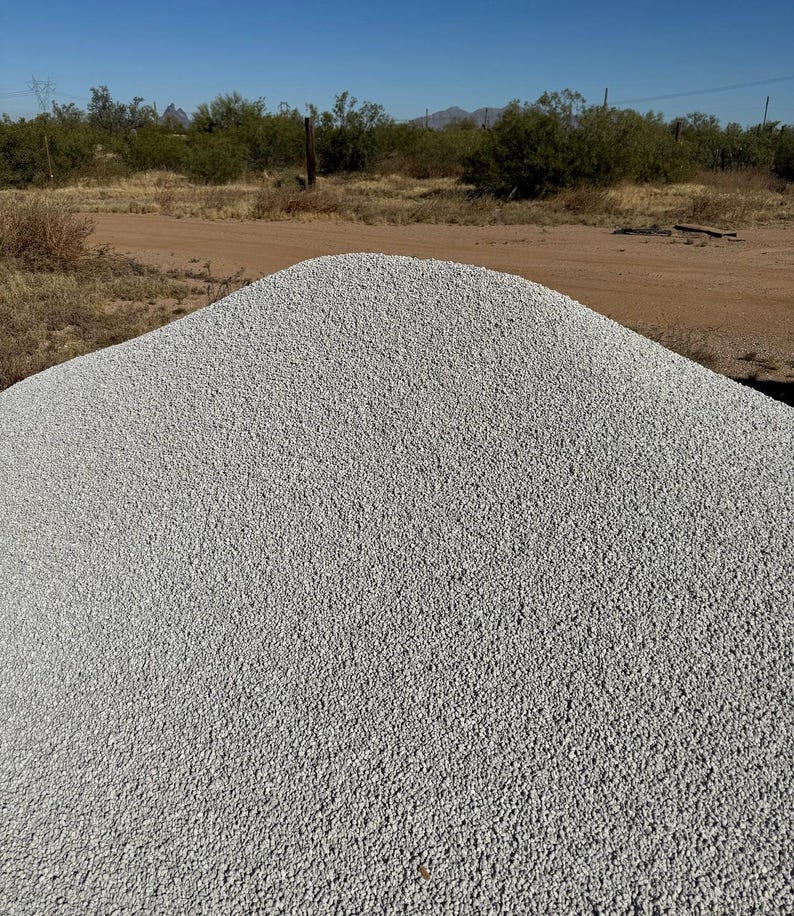 May include: A large pile of white gravel, likely used for landscaping or construction.