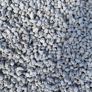 May include: A close-up view of a pile of white lava rocks. The rocks are small and irregular in shape, with a rough, porous texture.