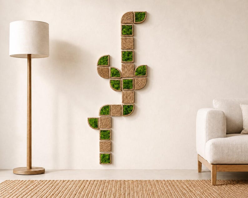 May include: A vertical wall art installation composed of modular square and semi-circular tiles. Each tile features either a textured natural jute rope coil pattern or a vibrant green preserved moss insert, arranged in a branching cactus-like shape.