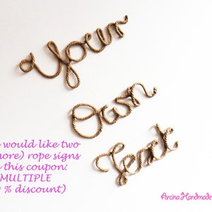 May include: A decorative sign made of twisted brown rope forming the cursive words your own text. The letters are arranged in three lines against a plain background. The rope has a natural tan color and a textured, fibrous appearance throughout.
