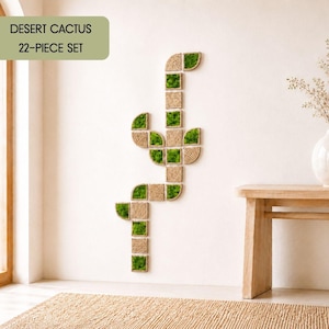 May include: A 22-piece wall art set titled Desert Cactus, composed of square and curved modular tiles featuring natural green moss and coiled tan rope textures arranged in a vertical cactus shape on a plain wall surface.