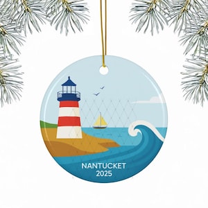 May include: Circular ceramic Christmas ornament depicting a lighthouse with red and white stripes, a sailboat, and a wave. The ornament has a blue sky background and the text "NANTUCKET 2025". A gold string is attached for hanging.