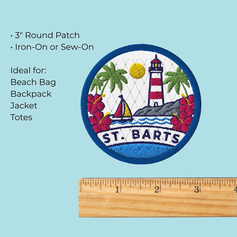 May include: A round 3-inch embroidered patch featuring a red and white lighthouse, a sailboat, palm trees, and red hibiscus flowers against a white background with a net pattern. The text ST. BARTS is embroidered in blue at the bottom of the patch.