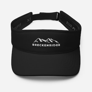 Puede incluir: Visera negra con una cordillera de montañas bordada en blanco y el texto "Breckenridge" en la parte delantera.